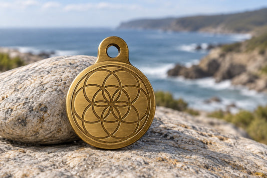 Attune pendant in brushed gold, front showing interlocking-circle geometry