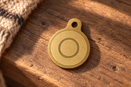 Front of the Origin pendant in brushed gold on a timber bench